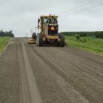 Grader constructing a gravel road test section