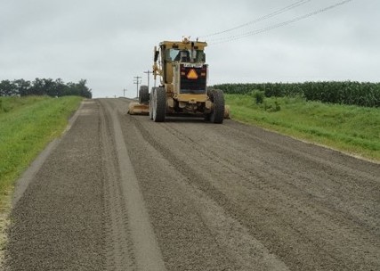 Grader constructing a gravel road test section
